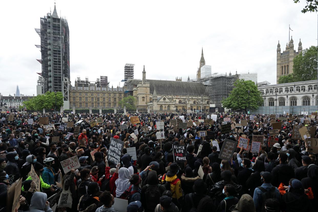 Protesters gather in Parliament Square in front of the Palace of Westminster in  central London after attending a demonstration outside the US Embassy, on June 7, 2020, organised to show solidarity with the Black Lives Matter movement in the wake of the killing of George Floyd, an unarmed black man who died after a police officer knelt on his neck in Minneapolis. - Taking a knee, banging drums and ignoring social distancing measures, outraged protesters from Sydney to London on Saturday kicked off a weekend of global rallies against racism and police brutality. (Photo by ISABEL INFANTES / AFP) (Photo by ISABEL INFANTES/AFP via Getty Images)