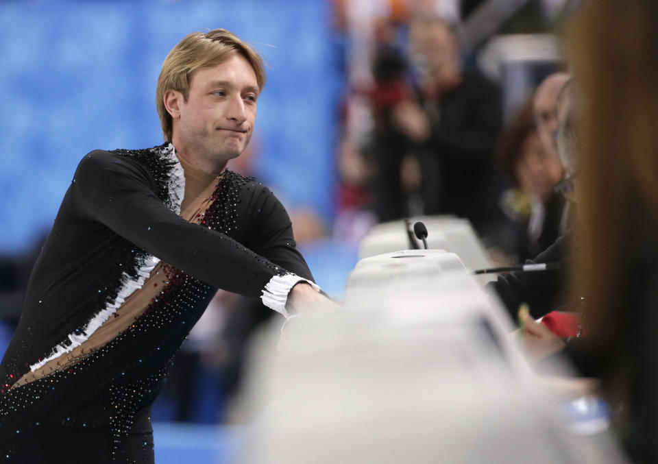 Evgeni Plushenko of Russia speaks with an official prior to pulling out of the men's short program figure skating competition due to illness at the Iceberg Skating Palace during the 2014 Winter Olympics, Thursday, Feb. 13, 2014, in Sochi, Russia. (AP Photo/Bernat Armangue)