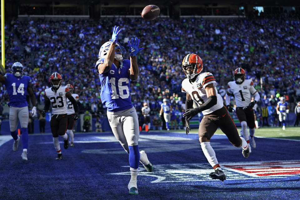 Seattle Seahawks wide receiver Tyler Lockett (16) reaches for a touchdown pass in front of Cleveland Browns cornerback Greg Newsome II (0) in the first half of an NFL football game, Sunday, Oct. 29, 2023, in Seattle. (AP Photo/Lindsey Wasson)
