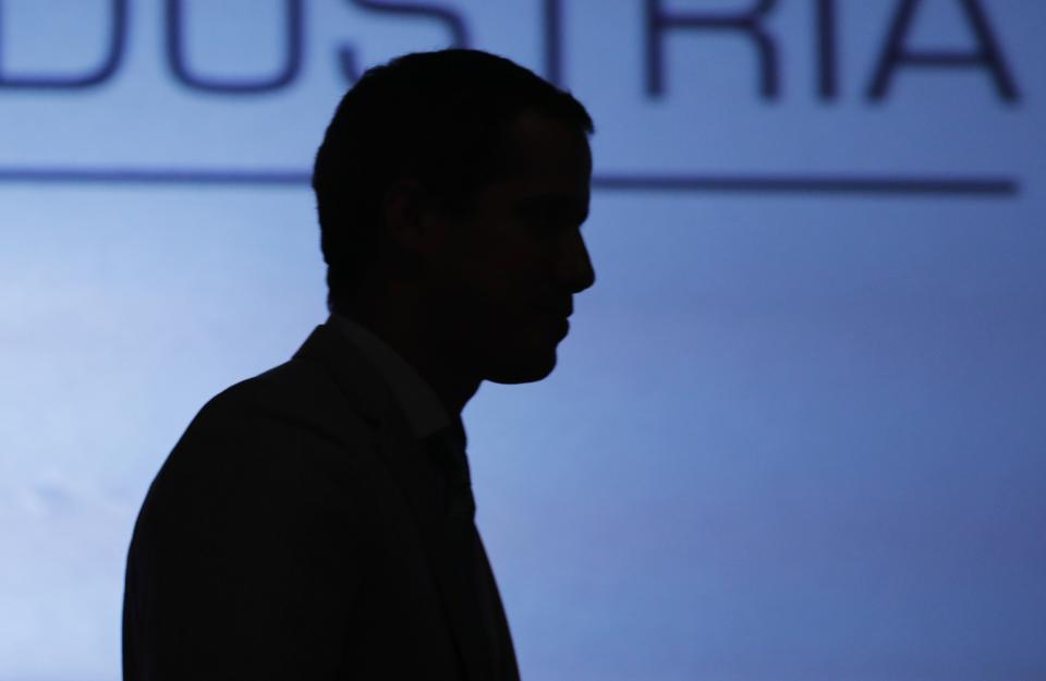 Venezuela's self proclaimed President Juan Guaido is silhouetted as he attends the Conindustria congress in Caracas, Venezuela, Wednesday, June 26, 2019. Jorge Rodríguez, spokesman for Venezuelan President Nicolas Maduro said Wednesday they have foiled a plot to overthrow the government that included assassinating President Nicolás Maduro and his closest political allies, and that plotters wanted to edge Guaidó from Venezuela’s political landscape. (AP Photo/Ariana Cubillos)
