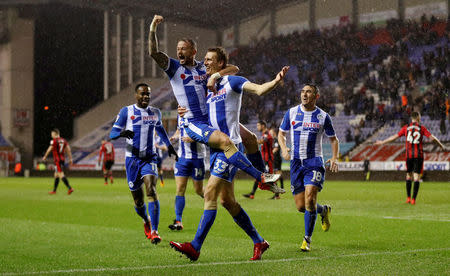 Soccer Football - FA Cup Third Round Replay - Wigan Athletic vs AFC Bournemouth - DW Stadium, Wigan, Britain - January 17, 2018 Wigan Athletic’s Dan Burn celebrates scoring their second goal with Noel Hunt and team mates Action Images via Reuters/Carl Recine