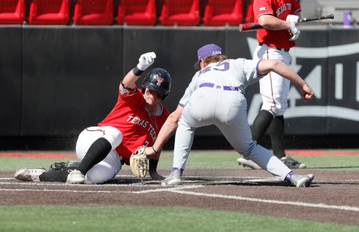 Texas Tech&#39;s Jace Jung (2) slides safe into home plate under the tag of Kansas State pitcher Dillon Pearson (45) during a Big 12 Conference game Saturday at Dan Law Field at Rip Griffin Park.