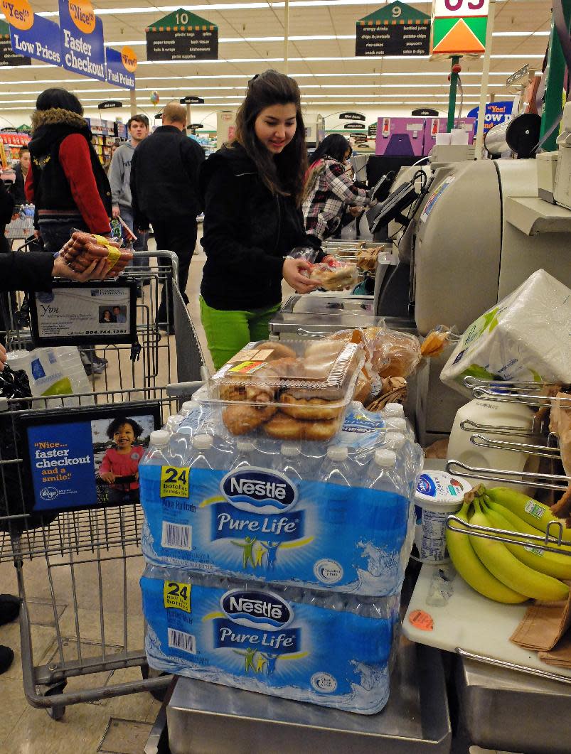 Tanaz Rahin of the South Hills region of Charleston. W.Va. drove across town to South Charleston to find water following a chemical spill on the Elk River that compromised the public water supply of eight counties on Thursday, Jan. 9, 2014. (AP Photo/Tyler Evert)