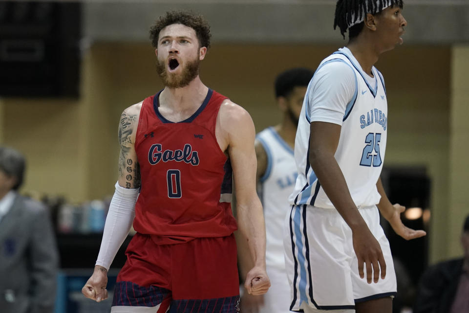 Saint Mary's guard Logan Johnson (0) reacts as he passes San Diego center Steven Jamerson II, right, during the second half of an NCAA college basketball game Thursday, Feb. 16, 2023, in San Diego. (AP Photo/Gregory Bull)