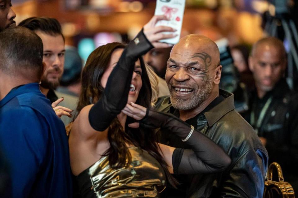 Mike Tyson poses for a selfie with model Brooks Nader after they placed sports bets during the launch event at the Seminole Hard Rock Hotel & Casino Hollywood, Thursday, Dec. 7, 2023.