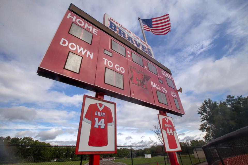 An image of Chris Gray’s retired No. 14 jersey hangs under the scoreboard at Manalapan High School in Manalapan, NJ Tuesday, August 15, 2023.