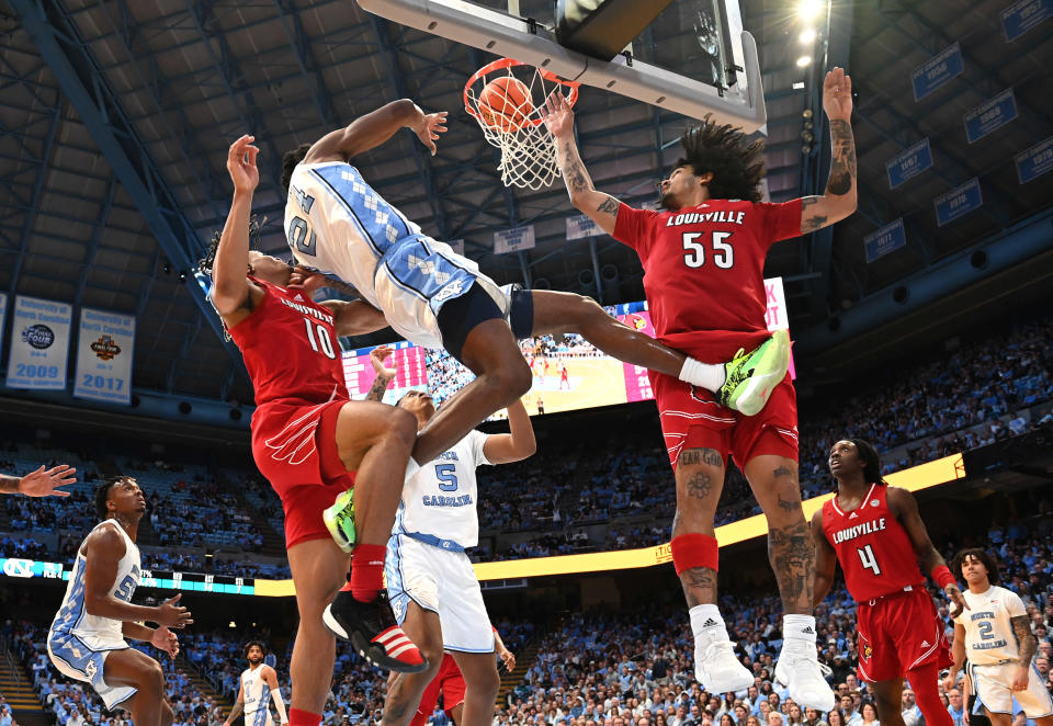 Jan 17, 2024; Chapel Hill, North Carolina, USA; North Carolina Tar Heels forward Jae’Lyn Withers (24) scores as Louisville Cardinals forward Kaleb Glenn (10) and guard Skyy Clark (55) defend in the second half at Dean E. Smith Center. Mandatory Credit: Bob Donnan-USA TODAY Sports