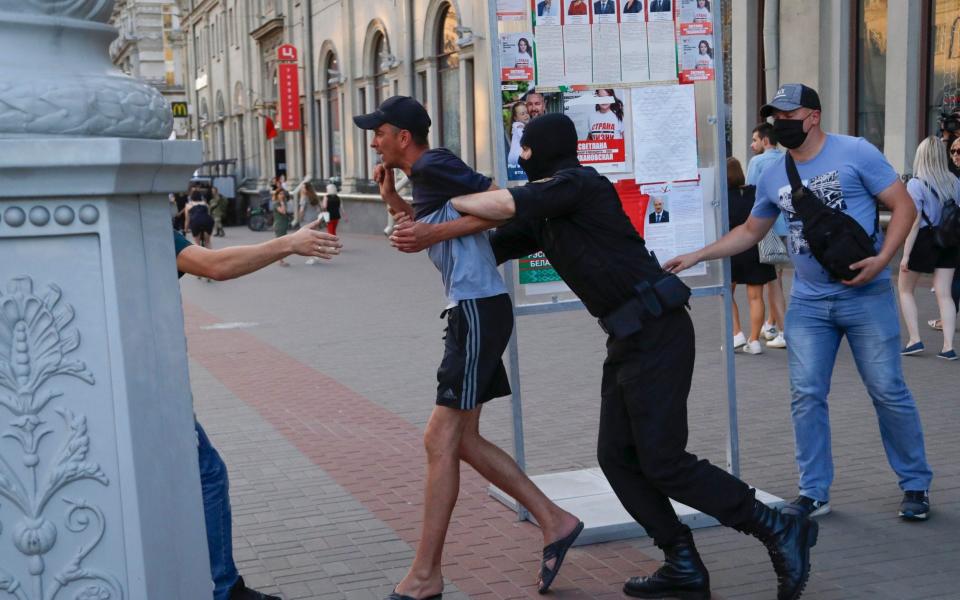 Belarusian police officers detain a man in Minsk, Belarus, Saturday, Aug. 8, 2020 - AP