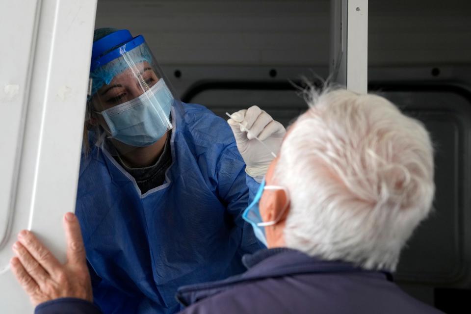 A member of the medical staff at the National Public Health Organisation conducts a COVID-19 rapid test on a man in Athens, Greece, on Nov. 15, 2021.