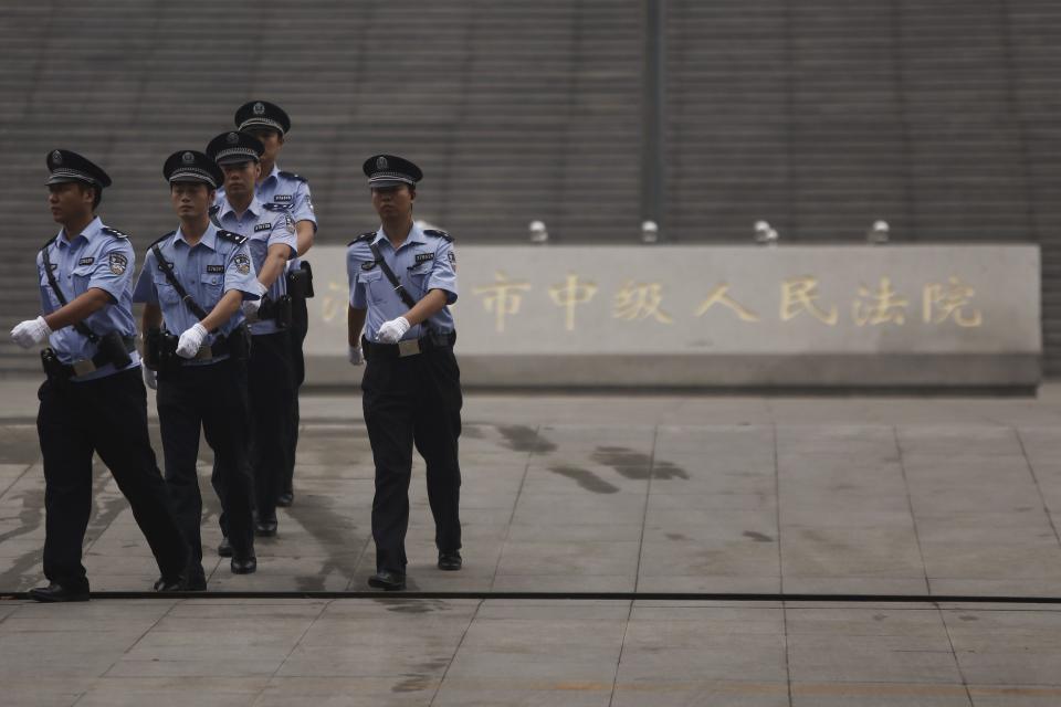 Policemen patrol near the entrance of the Jinan Intermediate People's Court where the trial of disgraced Chinese politician Bo will be held, in Jinan