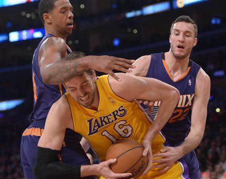 Los Angeles Lakers forward Pau Gasol (16) is defended by Phoenix Suns forward Channing Frye (8) and center Miles Plumlee (22) at Staples Center. Kirby Lee-USA TODAY