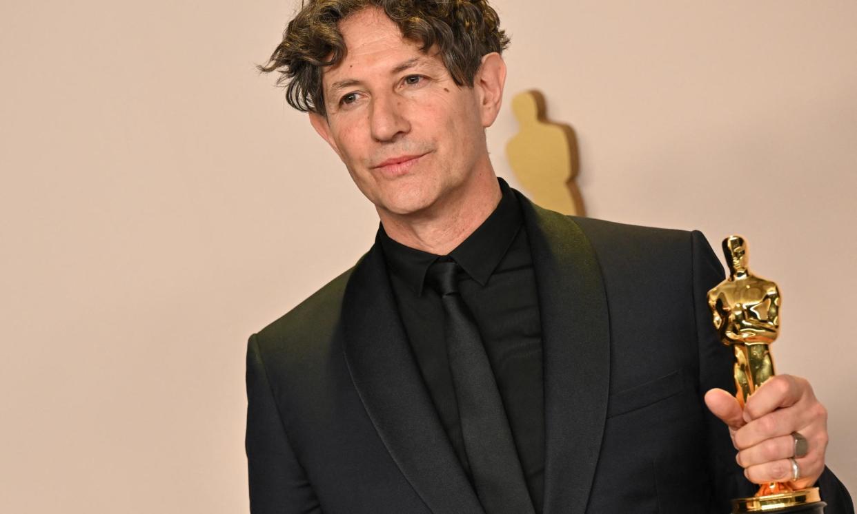 <span>Jonathan Glazer with the Oscar he won for best international film for The Zone of Interest.</span><span>Photograph: Robyn Beck/AFP/Getty Images</span>