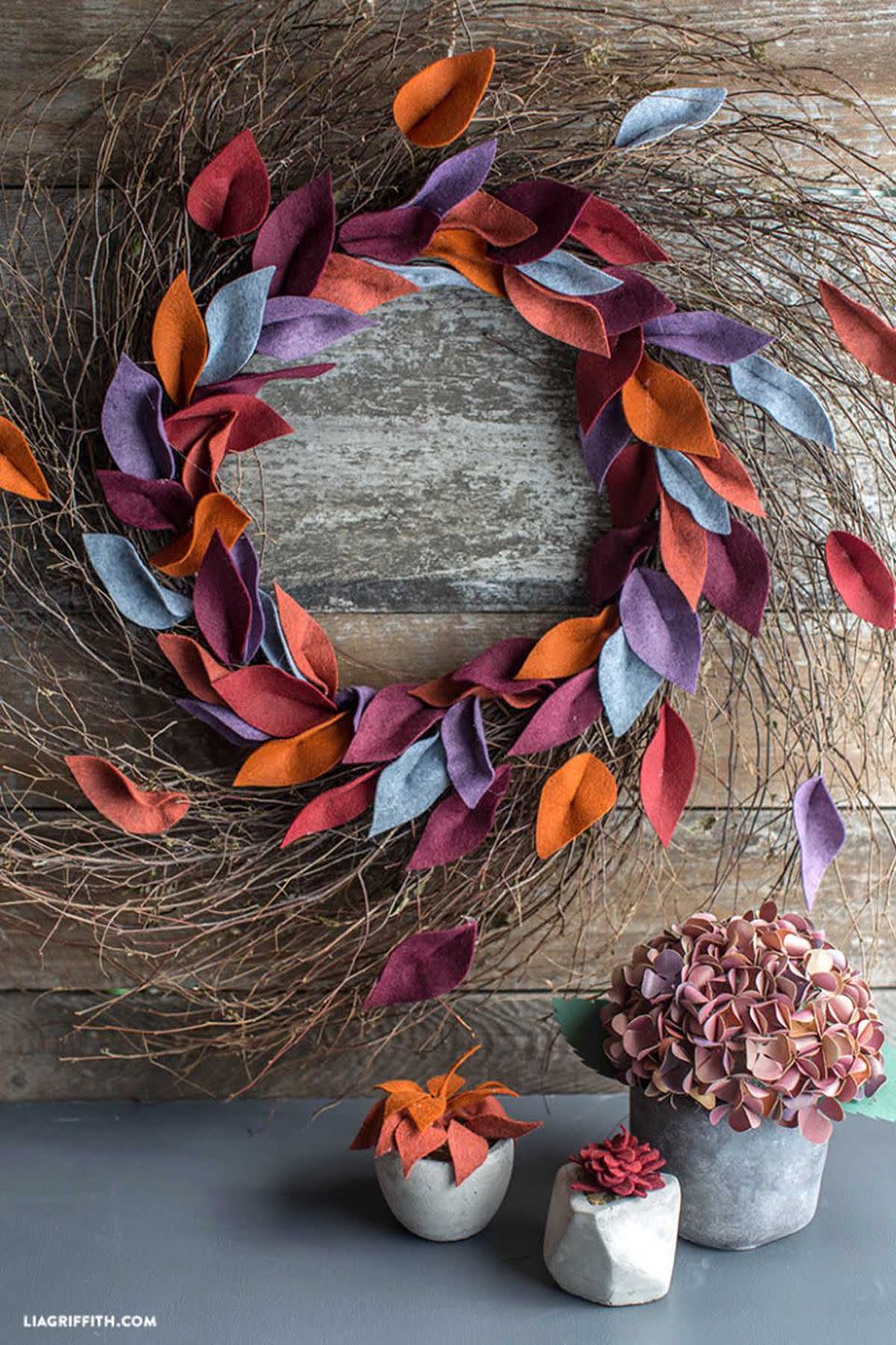 <p>Burnt orange, maroon, purple, and blue leaves come together beautifully to make this door decoration.</p><p><strong>Get the tutorial at <a href="https://go.redirectingat.com?id=74968X1596630&url=https%3A%2F%2Fliagriffith.com%2Ffelt-leaf-wreath%2F%3Fcrlt.pid%3Dcamp.662Dw2vYXJiU&sref=https%3A%2F%2Fwww.womansday.com%2Fhome%2Fcrafts-projects%2Fhow-to%2Fg2544%2Ffall-wreaths%2F" rel="nofollow noopener" target="_blank" data-ylk="slk:Lia Griffith;elm:context_link;itc:0;sec:content-canvas" class="link ">Lia Griffith</a>.</strong> </p><p><strong>RELATED:</strong> <a href="https://www.womansday.com/food-recipes/food-drinks/g3165/best-comfort-food-recipes/" rel="nofollow noopener" target="_blank" data-ylk="slk:Simple Comfort Food Recipes for a Cozy Night at Home;elm:context_link;itc:0;sec:content-canvas" class="link ">Simple Comfort Food Recipes for a Cozy Night at Home</a></p>