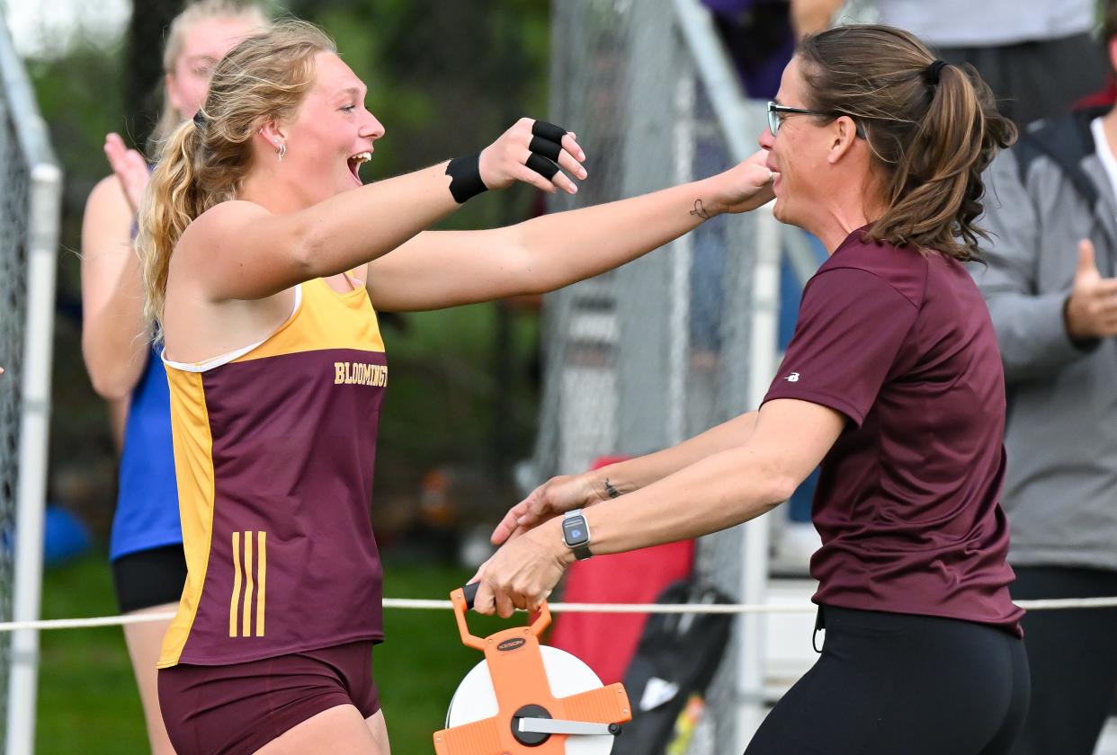 Bloomington North’s Hadley Lucas celebrates with throws coach Sara Hamidovic after throwing a school and meet record 54-10¾ in the shot put during the Conference Indiana track meet at Bloomington North on Friday, April 26, 2024.