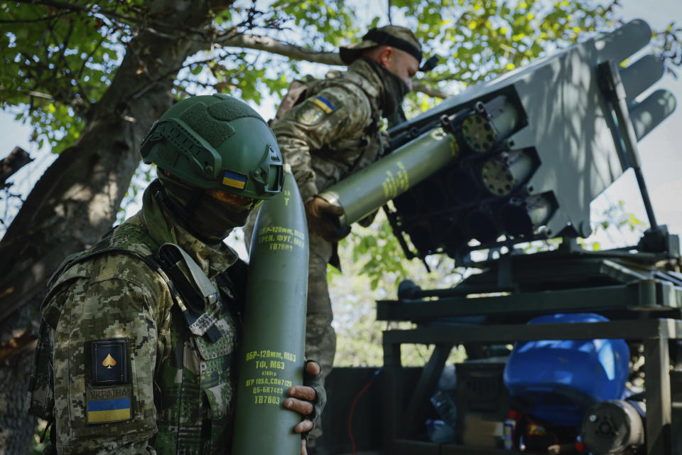 Ukrainian soldiers prepare a Croatian RAK-SA-12 128mm multiple rocket launcher to fire towards the Russian positions on the frontline near Bakhmut in the Donetsk region, Ukraine, Monday, July 10, 2023. (Roman Chop via AP)