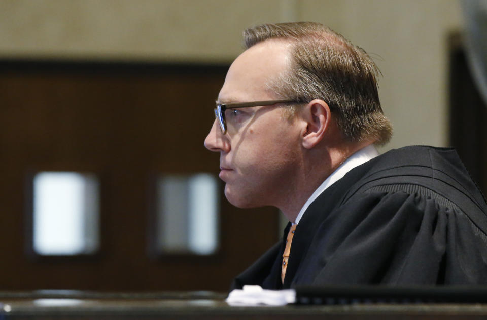 Judge Thad Balkman listens during closing arguments in Oklahoma's ongoing opioid drug lawsuit against Johnson & Johnson, Monday, July 15, 2019, in Norman, Okla. (AP Photo/Sue Ogrocki, Pool)