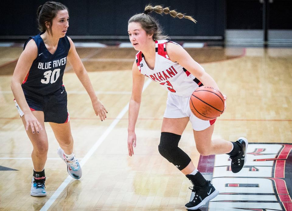 Wapahani's Kendyl Thrasher slips past Blue River's Sami Loveless during their game at Wapahani High School Tuesday, Nov. 30, 2021.