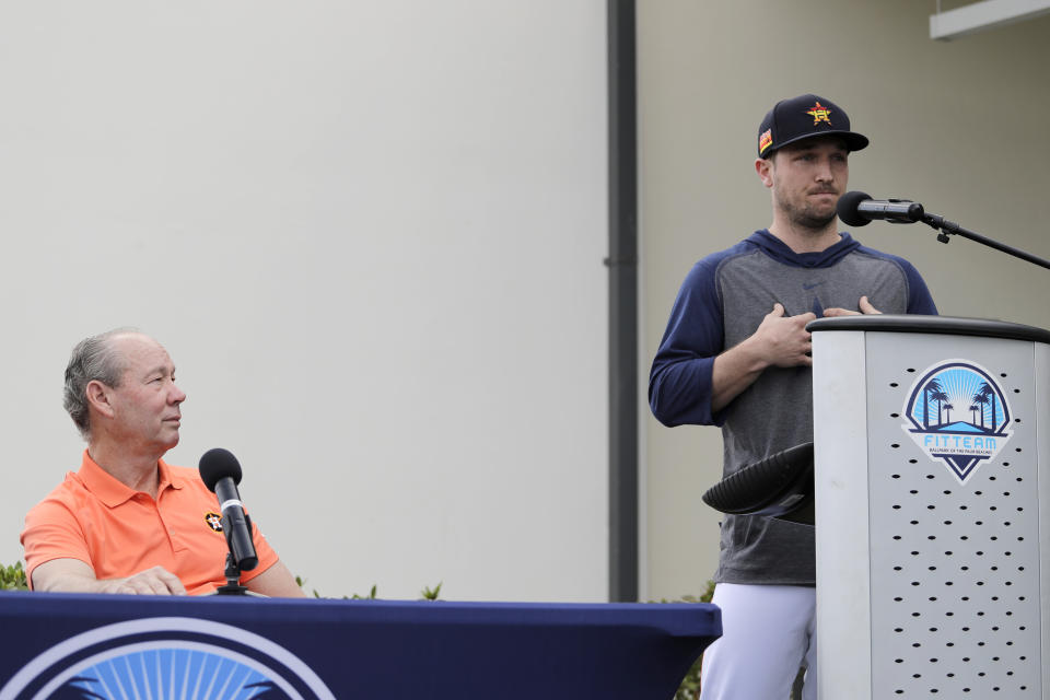 Houston Astros' Alex Bregman, right, delivers a statement as Astros owner Jim Crane listens during a news conference before the start of the first official spring training baseball practice for the team Thursday, Feb. 13, 2020, in West Palm Beach, Fla. (AP Photo/Jeff Roberson)