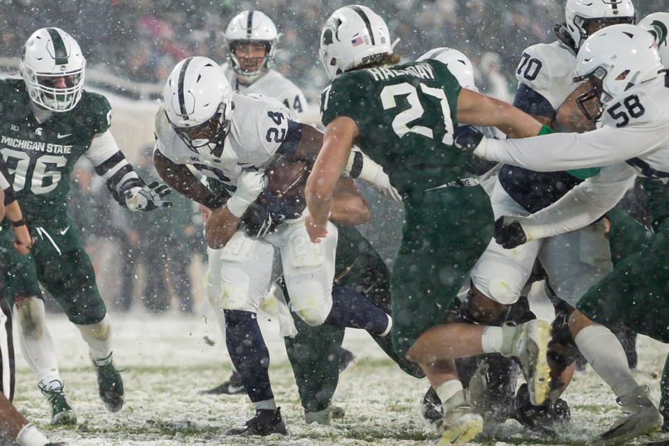Penn State running back Keyvone Lee (24) runs the ball during the fourth quarter against Michigan State during their game in 2021 at Spartan Stadium.
