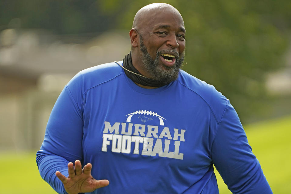 Murrah High School football coach Marcus Gibson encourages his players during practice, Wednesday, Aug. 31, 2022, in Jackson, Miss. The city's low water pressure concerns Gibson, limiting his options for washing practice uniforms, towels and other gear his players wear. The recent flood worsened Jackson's longstanding water system problems and the state Health Department has had Mississippi's capital city under a boil-water notice since late July. (AP Photo/Rogelio V. Solis)