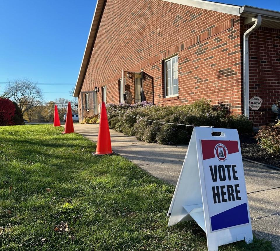 A Monroe County voter stands in the doorway at Eastview Church of The Nazarene on Nov. 7, 2023 to cast her ballot.