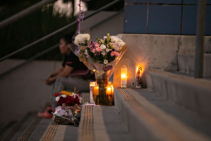 LOS ANGELES, CA - SEPTEMBER 15: Students and community members place flowers and candles at Helen Bernstein High School where a teenage girl died of a overdose on Thursday, Sept. 15, 2022 in Los Angeles, CA. (Jason Armond / Los Angeles Times)