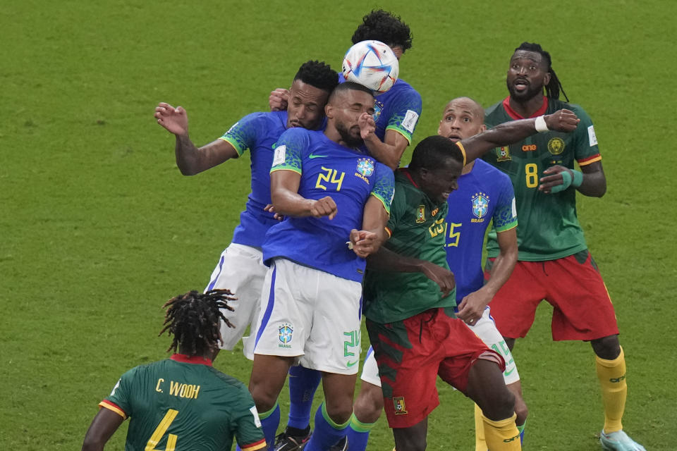 A group of players jumps for a header during the World Cup group G soccer match between Cameroon and Brazil, at the Lusail Stadium in Lusail, Qatar, Friday, Dec. 2, 2022. (AP Photo/Alessandra Tarantino)