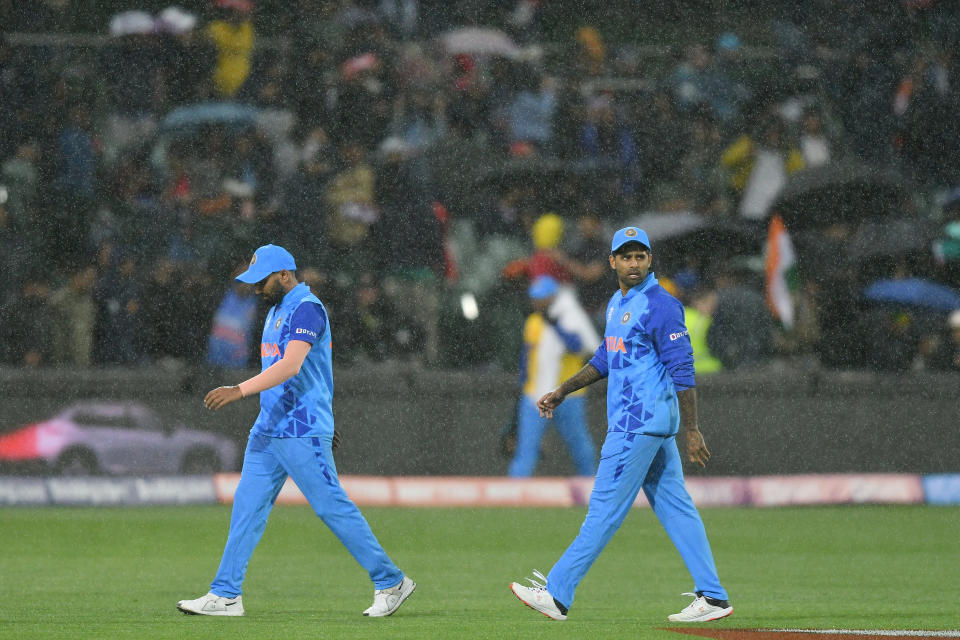 Indian team exit the field due to a rain delay.