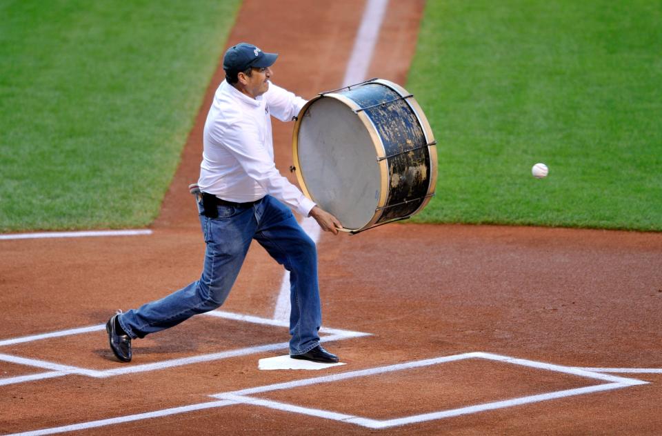 John Adams aims his drum at a ceremonial first pitch thrown by former player Carlos Baerga (not pictured) before a game against Minnesota, Aug 24, 2013, in Cleveland.