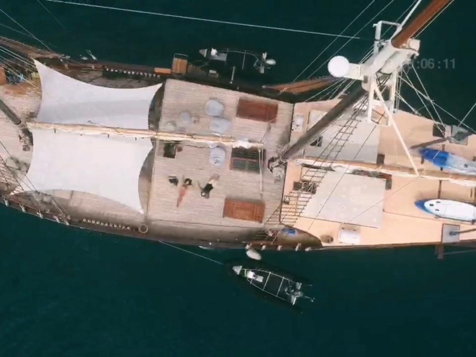 An overhead aerial drone shot of a sailing yacht with multiple decks.