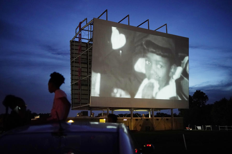 People watch a documentary called "Rebuilding Black Wall Street," during a drive-in screening of documentaries during centennial commemorations of the Tulsa Race Massacre, Wednesday, May 26, 2021, in Tulsa, Okla. (AP Photo/John Locher)