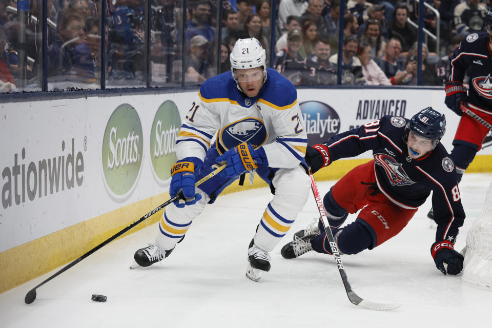 Buffalo Sabres' Kyle Okposo, left, skates behind the net as Columbus Blue Jackets' Stanislav Svozil defends during the first period of an NHL hockey game Friday, April 14, 2023, in Columbus, Ohio. (AP Photo/Jay LaPrete)
