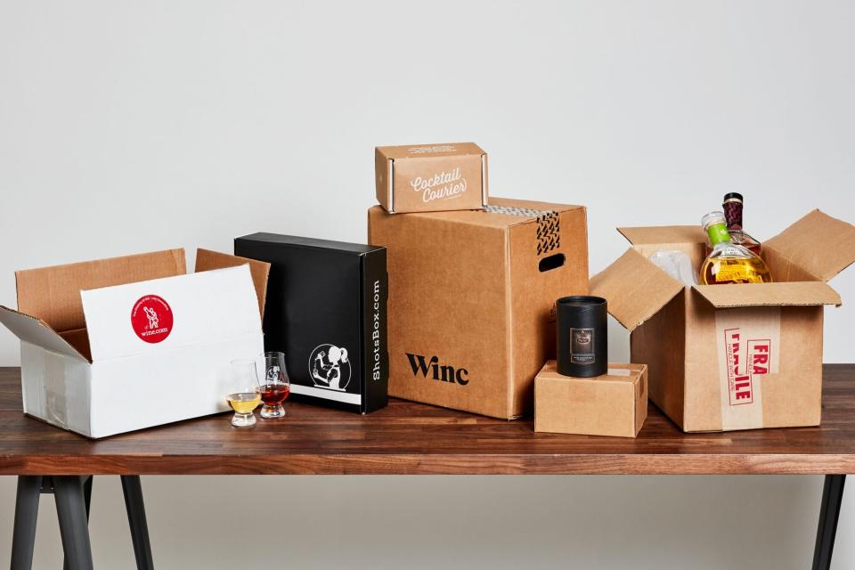 cardboard boxes containing alcohol shipments sitting on a wooden table