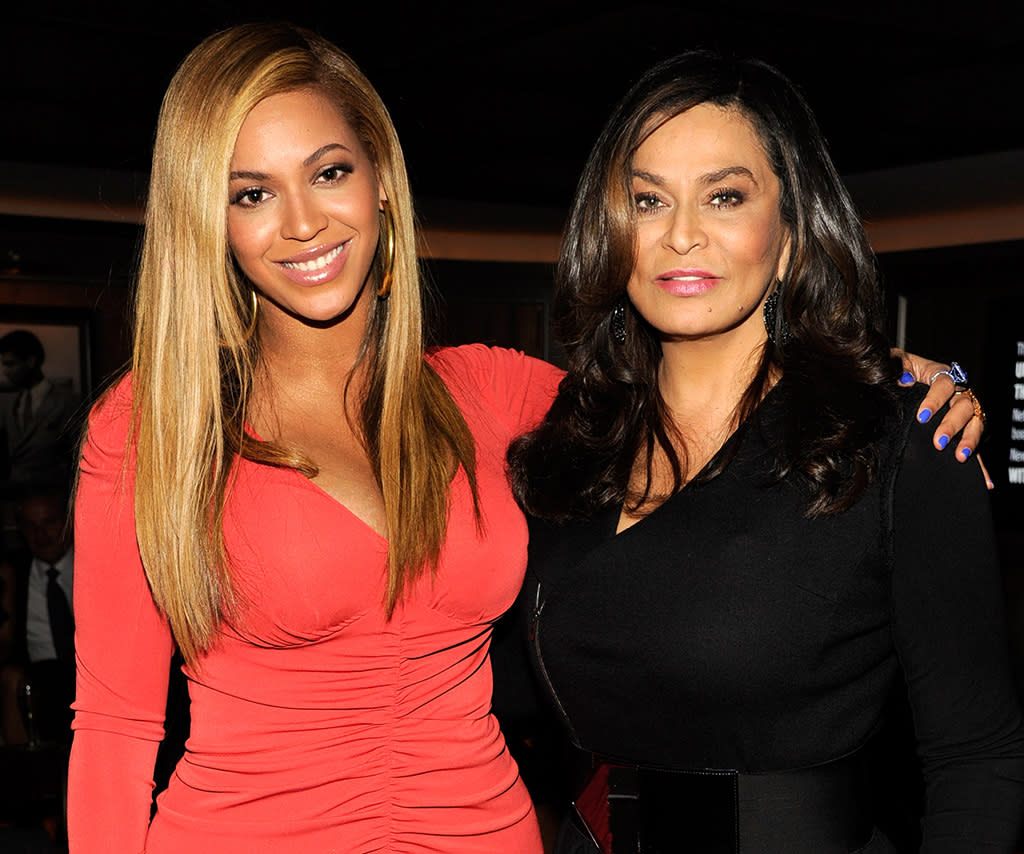 Beyoncé with her arm around her mom's shoulder.