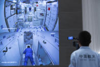 In this photo released by Xinhua News Agency, a worker monitors screens showing the interior of the Tianhe space station module after Chinese astronauts docked and enter it are displayed on large screens at the Beijing Aerospace Control Center in Beijing, on Thursday, June 17, 2021. China has launched the first three-man crew to its new space station in its the ambitious programs first crewed mission in five years (Jin Liwang/Xinhua via AP)