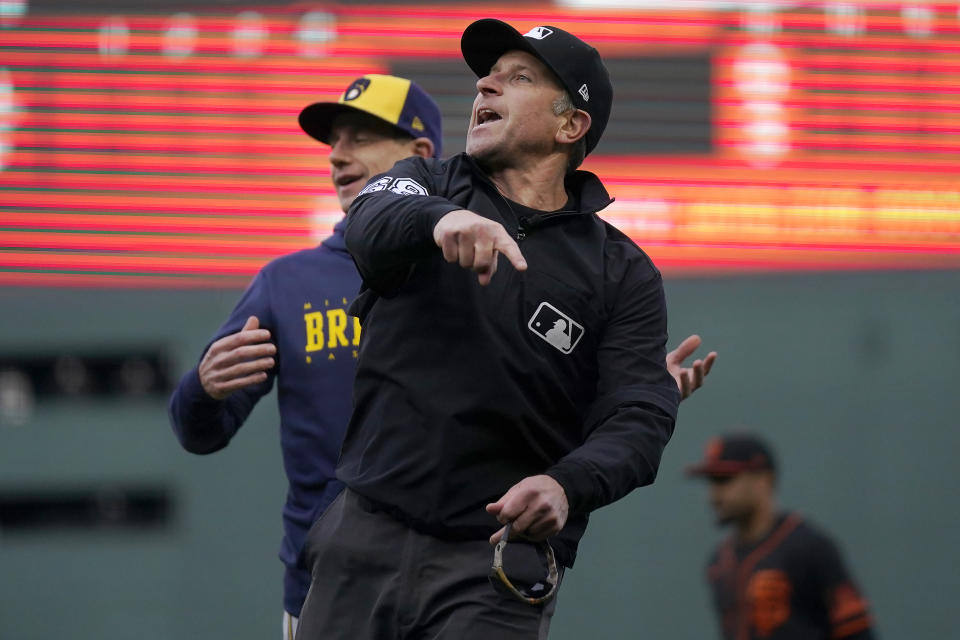 Milwaukee Brewers manager Craig Counsell, left, is ejected by umpire Chris Guccione during the fourth inning of the team's baseball game against the San Francisco Giants in San Francisco, Saturday, May 6, 2023. (AP Photo/Jeff Chiu)