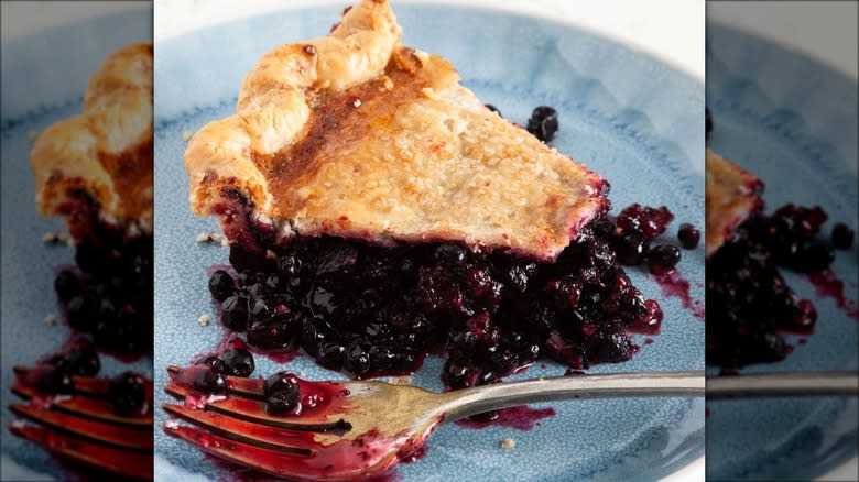 Huckleberry pie on blue plate