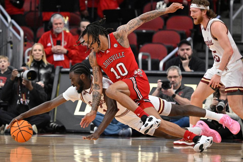 Mar 9, 2024; Louisville, Kentucky, USA; Boston College Eagles guard Prince Aligbe (10) dives for the ball with Louisville Cardinals forward Kaleb Glenn (10) during the first half at KFC Yum! Center. Mandatory Credit: Jamie Rhodes-USA TODAY Sports