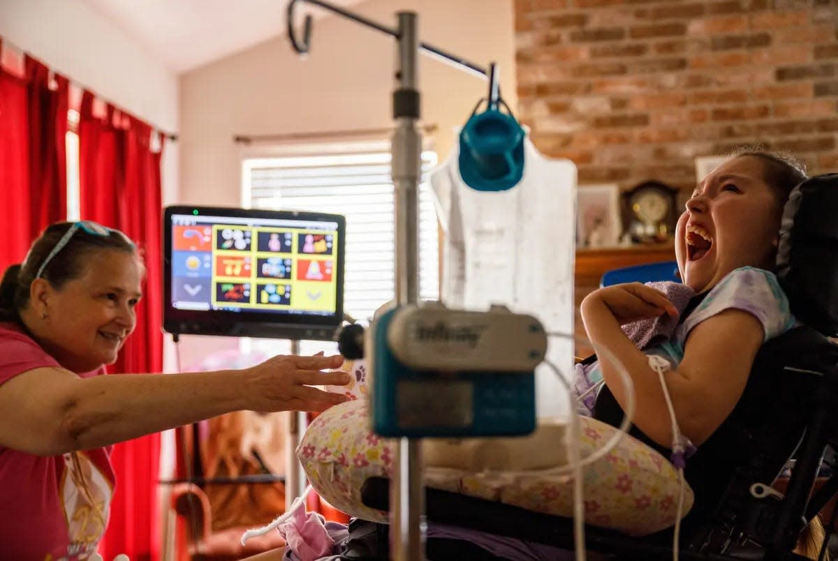 Laurie Sharp talks with her daughter, Logan Sharp, in the living room of their Pflugerville home on Saturday.