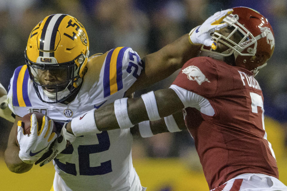 LSU running back Clyde Edwards-Helaire (22) stiff arms Arkansas defensive back Joe Foucha (7) in an NCAA college football game in Baton Rouge, La., Saturday, Nov. 23, 2019. (AP Photo/Matthew Hinton)