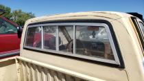 <p>The pass-through rear cab glass and the marks around the top of the cab show that a camper shell once lived here.</p>