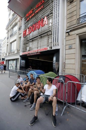 Fans of US singer Madonna camp next to the Olympia concert hall in Paris on Wednesday, a bay before her concert. The angry reaction on Friday to her short show was in sharp contrast to the enthusiastic cheers which greeted Madonna when she exited the stage at the Olympia theatre after barely three quarters of an hour on Thursday evening
