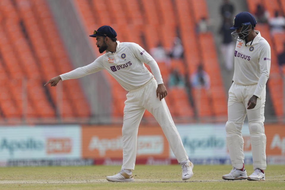 India's Virat Kohli, left, gestures during the fifth day of the fourth cricket test match between India and Australia in Ahmedabad, India, Monday , March 13, 2023. (AP Photo/Ajit Solanki)