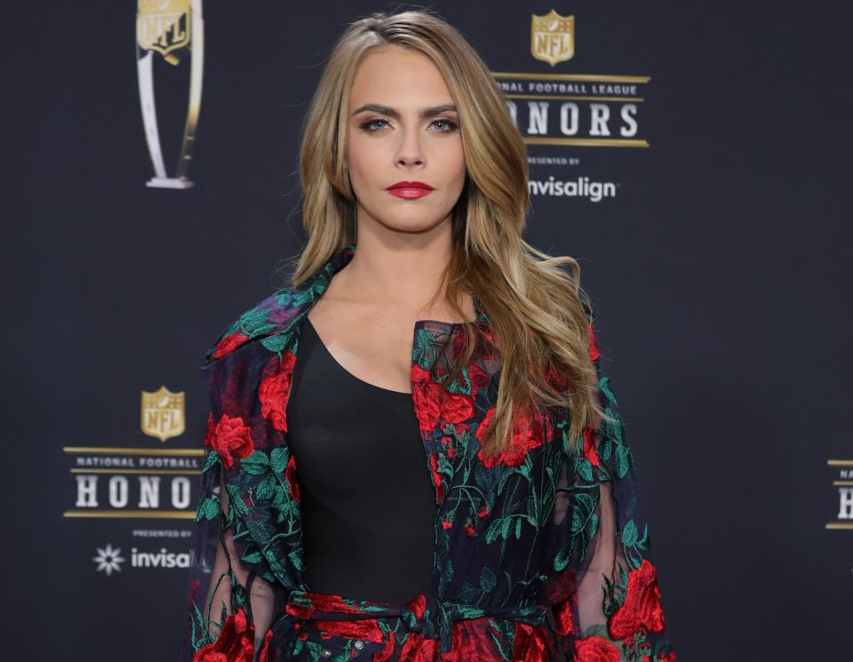 A close-up of Cara in a floral outfit