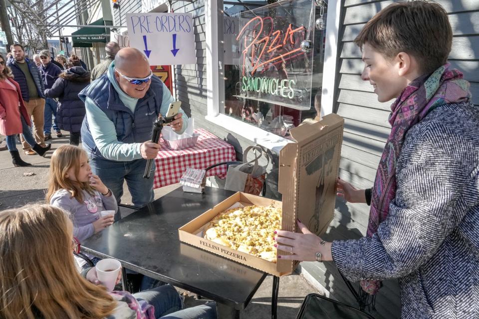 Sportswriter Eric Rueb snaps a photo before he, his kids and fellow Journal writer Amy Russo dig into the holy grail of seasonal foods: the Thanksgiving pie from Fellini Pizzeria.