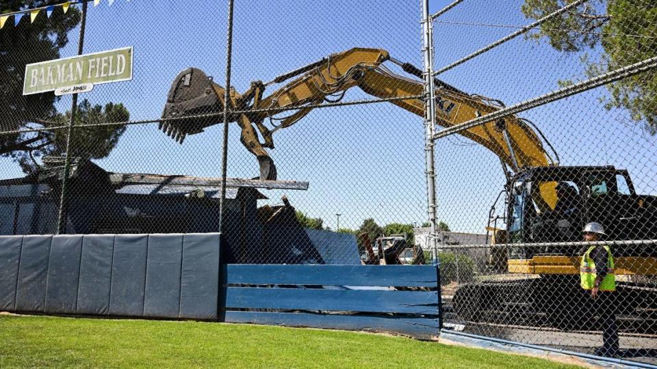 Fresno Mayor Jerry Dyer uses an excavator to demolish the 60-year-old field house at Bakman Field in Fresno’s Sunnyside area on Tuesday, July 11, 2023. Sunnyside Little Leaguers hope to play on a new field with a new snack bar, press box and restroom facility when the project is completed next spring.