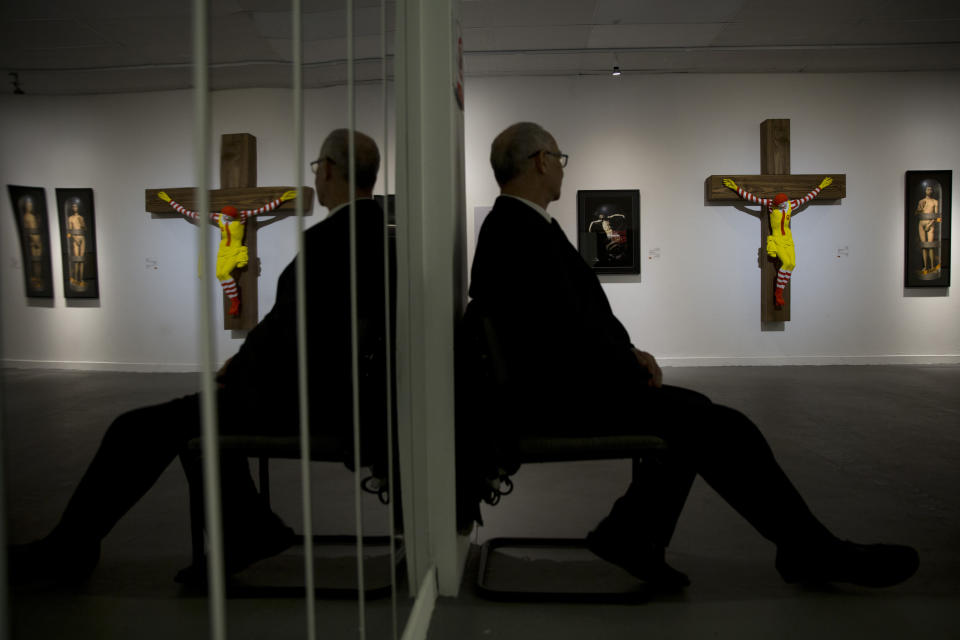 An artwork called "McJesus," which was sculpted by Finnish artist Jani Leinonen and depicts a crucified Ronald McDonald, is seen on display as part of the Haifa museum's "Sacred Goods" exhibit, in Haifa, Israel, Monday, Jan. 14, 2019. Hundreds of Christians calling for the sculpture's removal protested at the museum last week. (AP Photo/Oded Balilty)