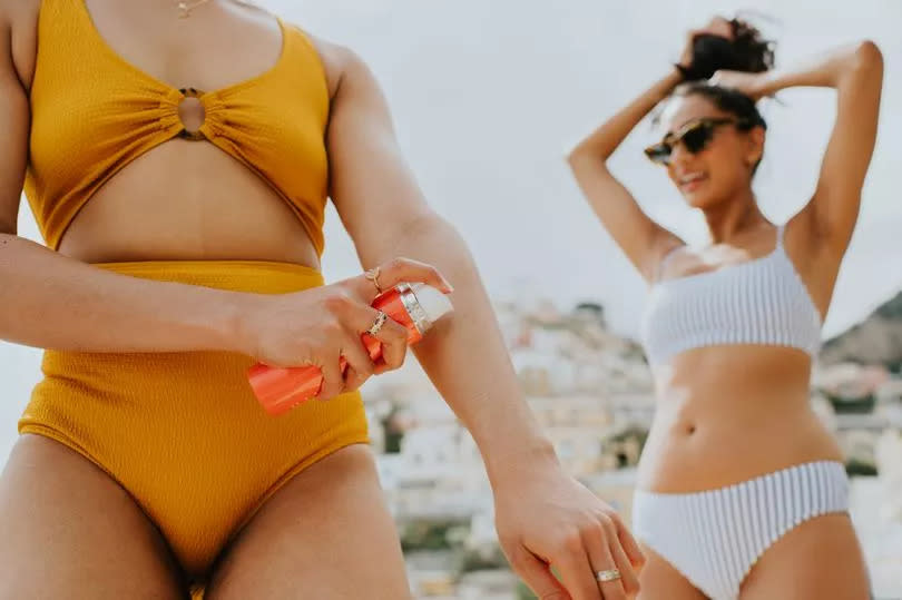 Woman applying suncream