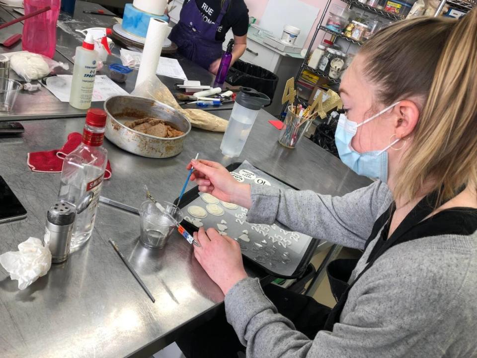 Staff are busy preparing orders at Sweet Revenge Bake Shop. (Aastha Shetty/CBC News - image credit)