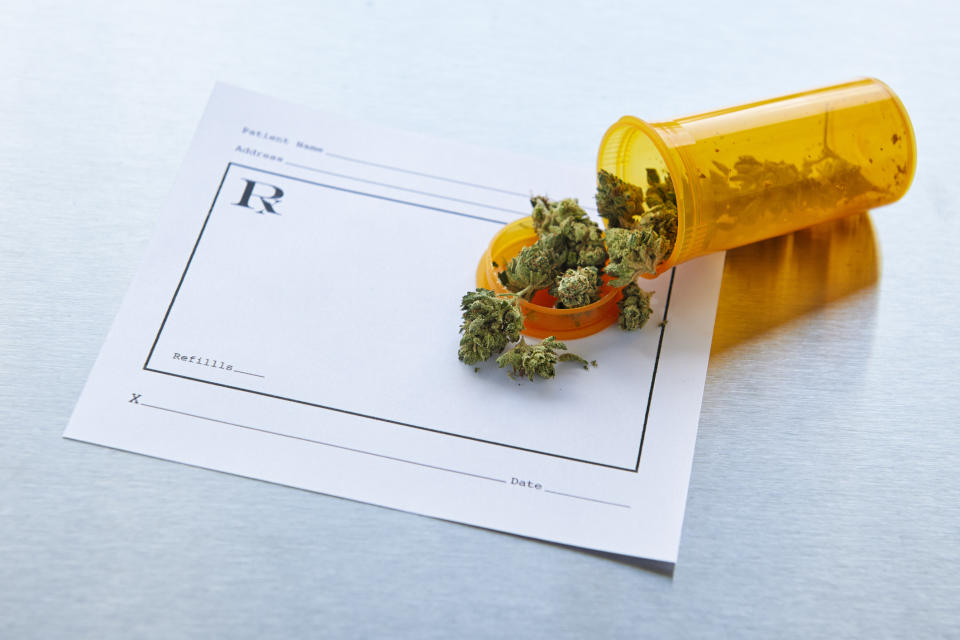Marijuana buds on a prescription pad.